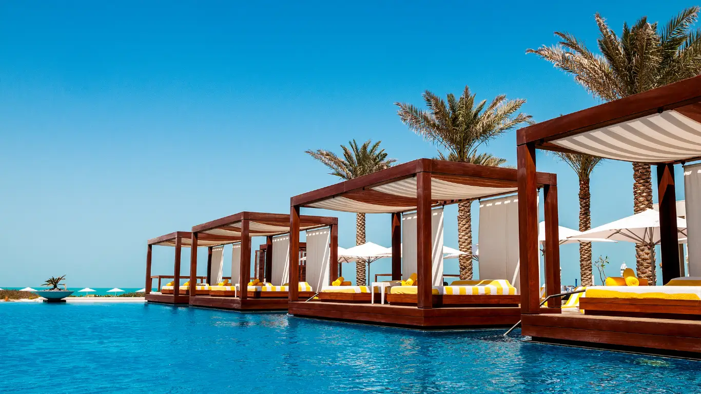 Beds in luxury resort villas surrounded by clear blue water
